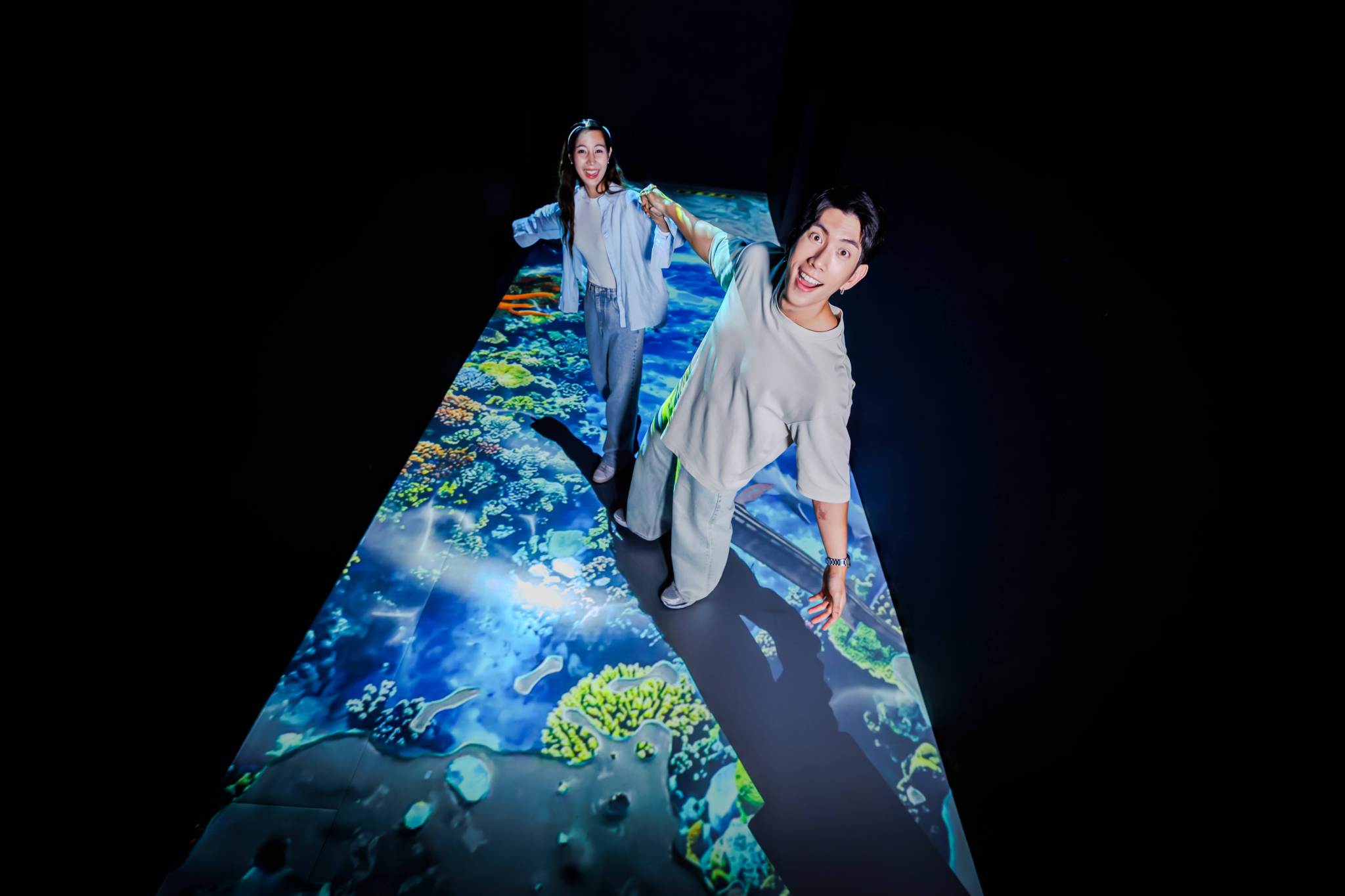 Couple Holding Hands on Interactive Underwater Projection