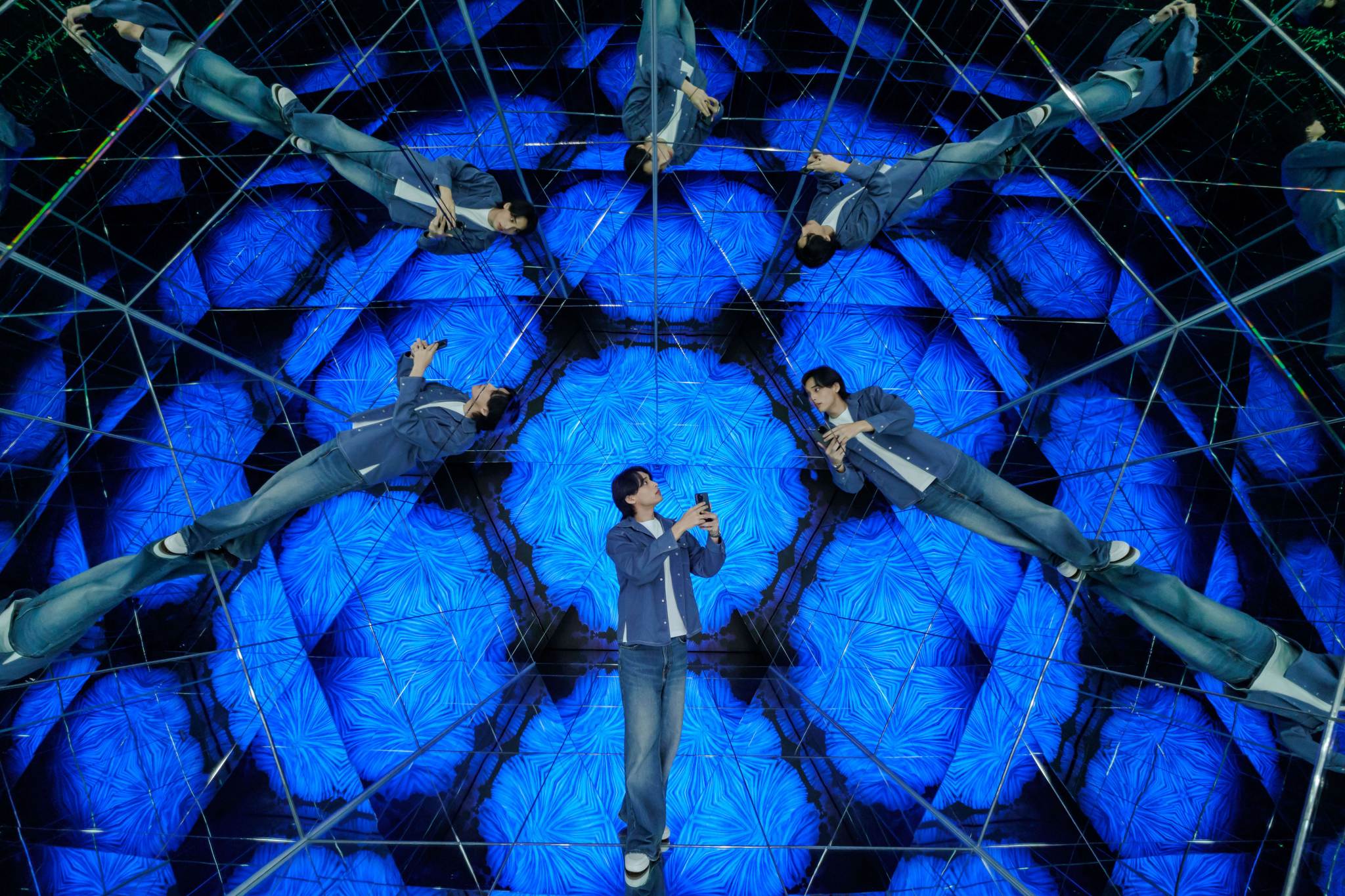 Man Standing in Kaleidoscope Mirror Room