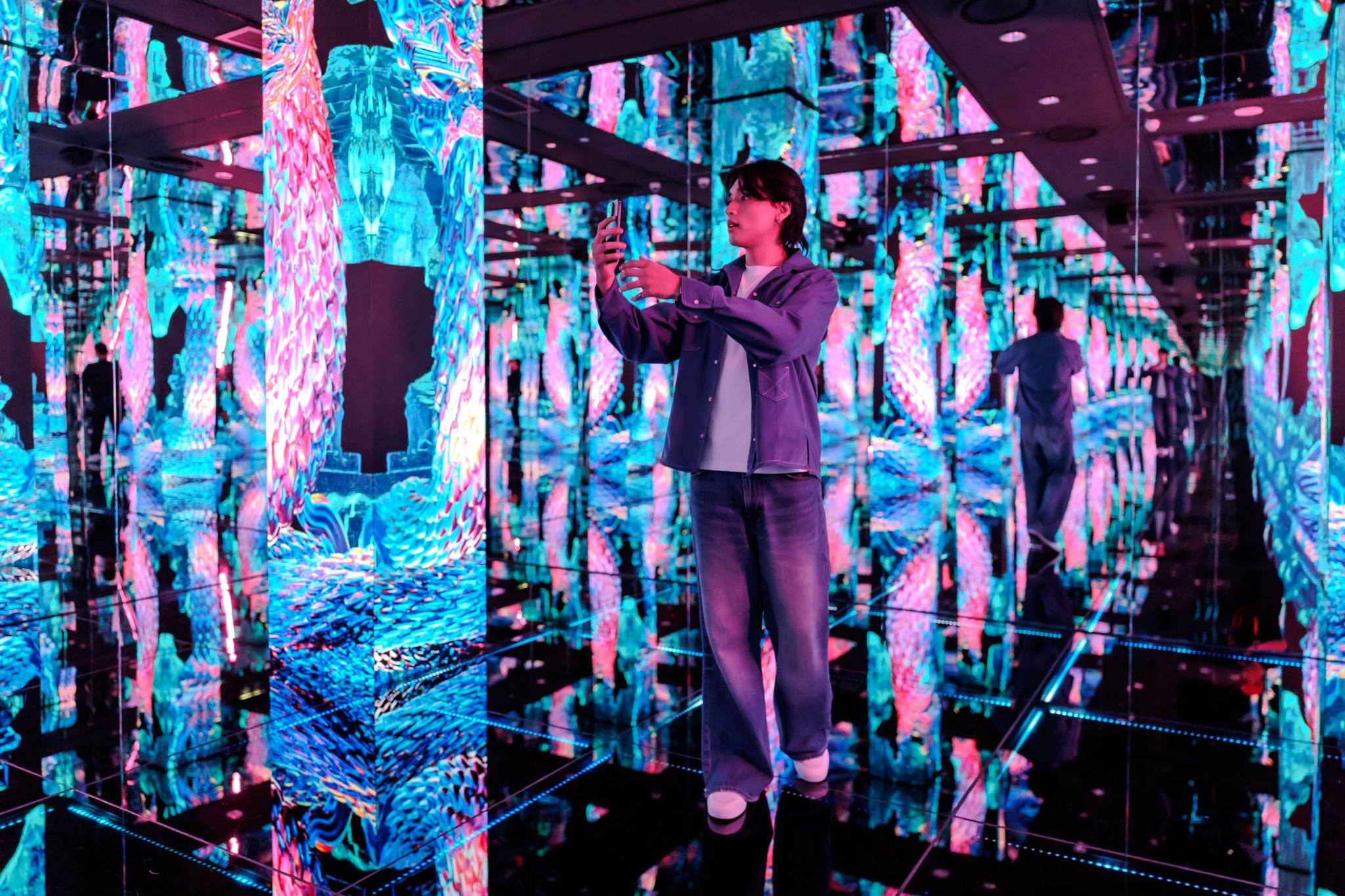Man Exploring Immersive Digital Art Installation