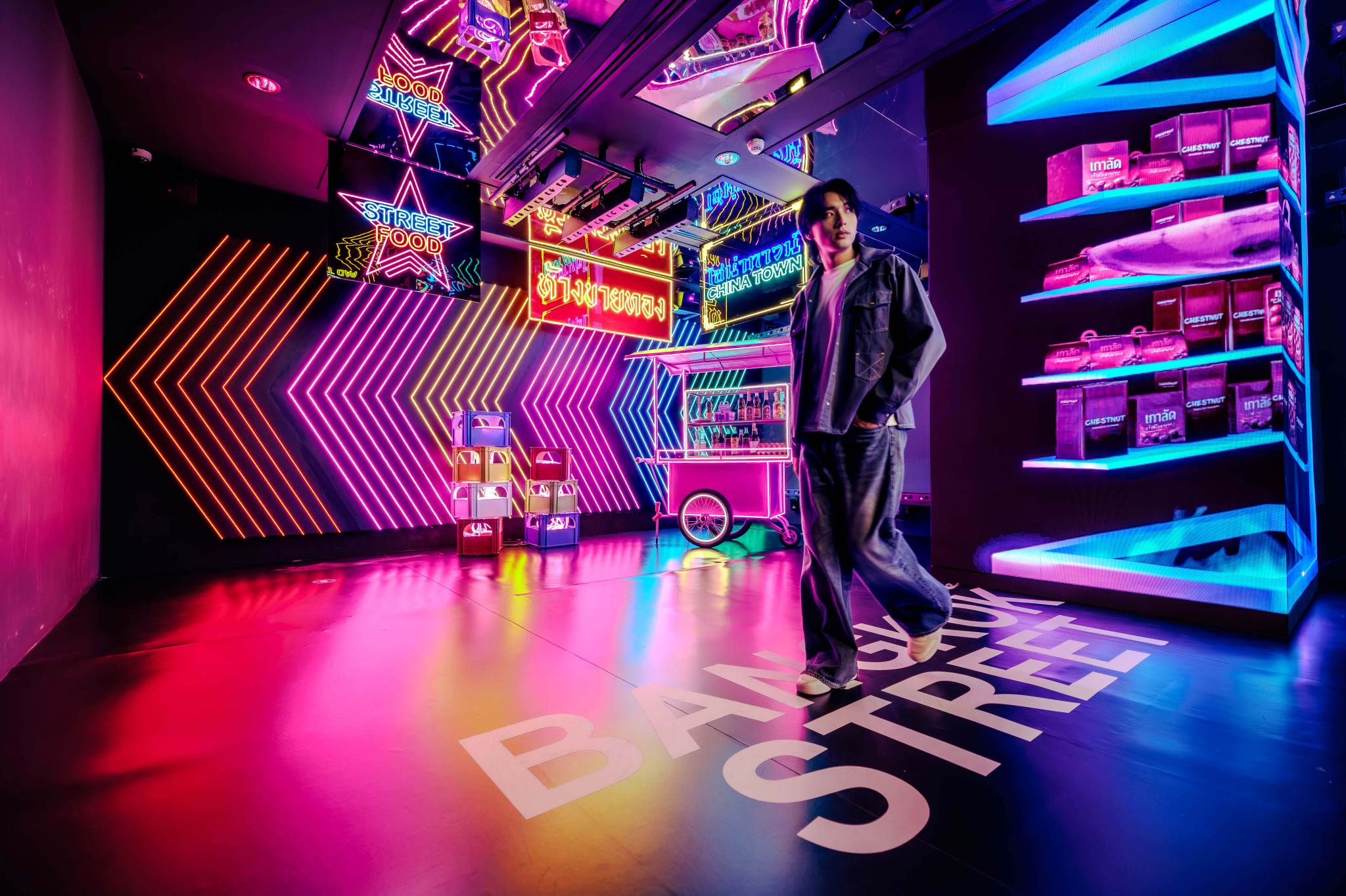Man Walking Through Bangkok Street Food Neon Exhibit