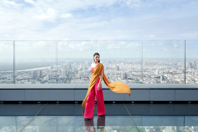Woman on King Power Mahanakhon Skywalk with Bangkok City View