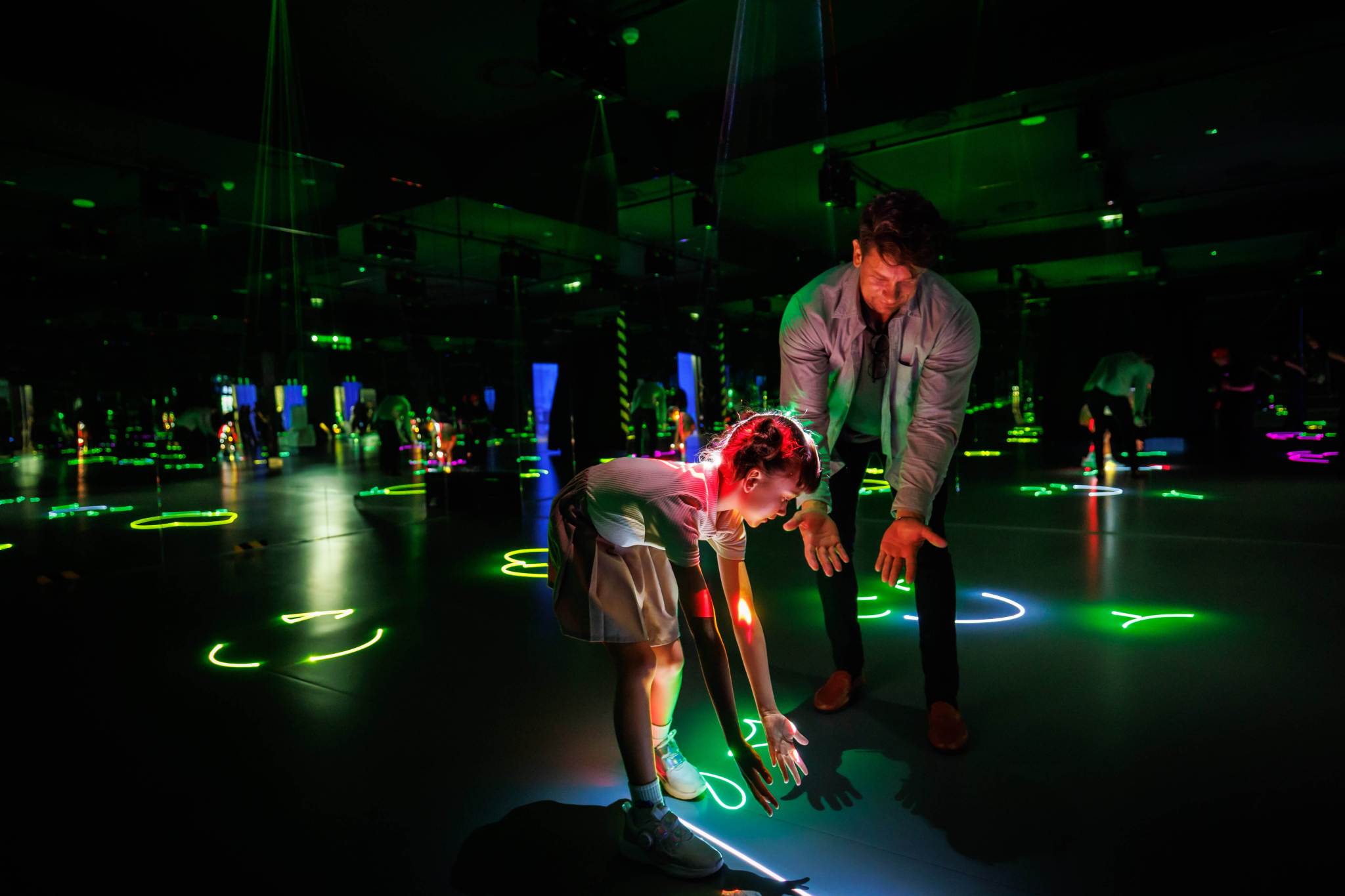 Father and Daughter Interacting with Light Floor Exhibit